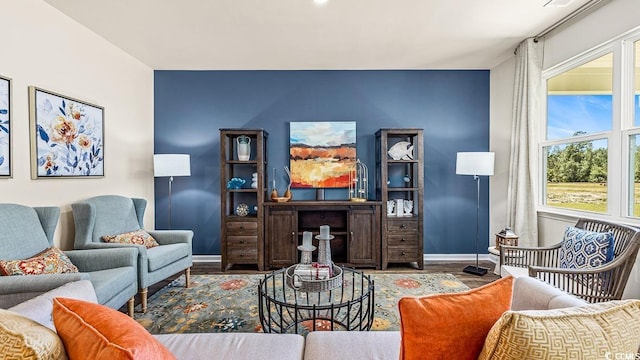 living room featuring baseboards and wood finished floors