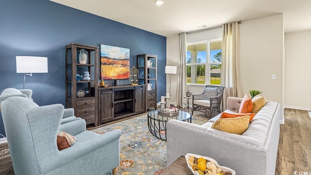 living room featuring baseboards and wood finished floors