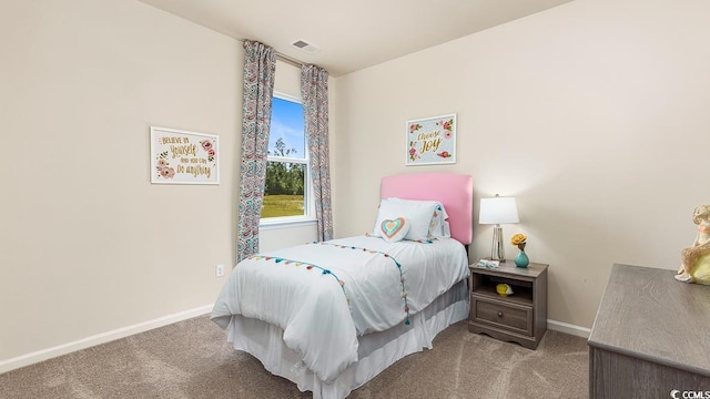 carpeted bedroom with visible vents and baseboards