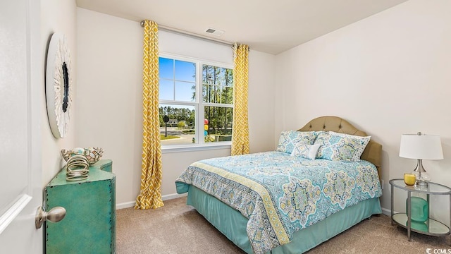 bedroom with visible vents, baseboards, and carpet