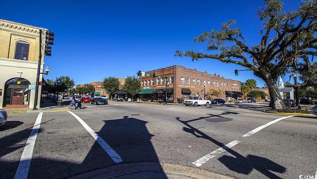 view of road featuring sidewalks, street lights, and curbs