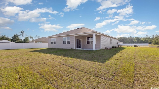 back of property featuring a patio, fence, and a lawn