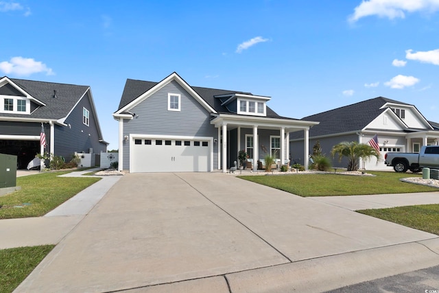 view of front of property featuring a front yard, a garage, and a porch