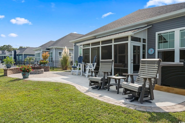 back of property featuring a patio, a sunroom, and a lawn