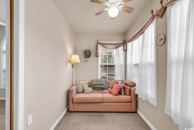 sitting room featuring light carpet and ceiling fan