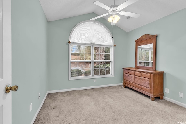 carpeted bedroom with multiple windows, lofted ceiling, and ceiling fan