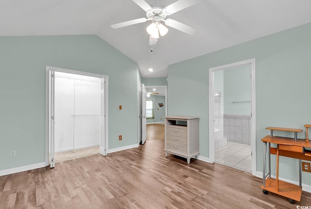 unfurnished room featuring light hardwood / wood-style flooring, ceiling fan, and lofted ceiling