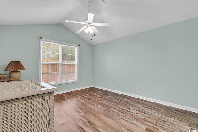 unfurnished bedroom featuring hardwood / wood-style flooring, ceiling fan, and lofted ceiling