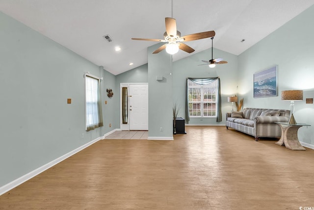 unfurnished living room featuring light wood-type flooring and vaulted ceiling