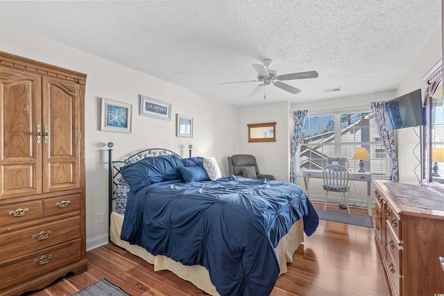 118 Gully Branch Ln Unit 3, Myrtle Beach, SC 29572 - bedroom featuring dark wood finished floors, visible vents, a ceiling fan, a textured ceiling, and baseboards