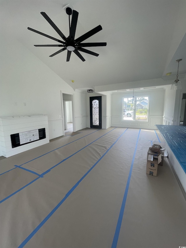 unfurnished living room featuring a fireplace, a ceiling fan, and high vaulted ceiling