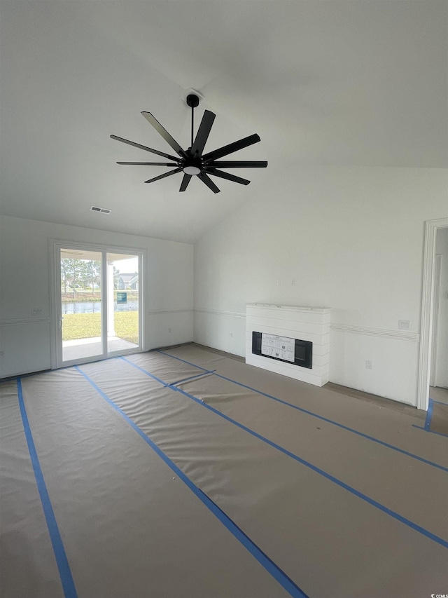 unfurnished living room featuring lofted ceiling, a ceiling fan, and a fireplace