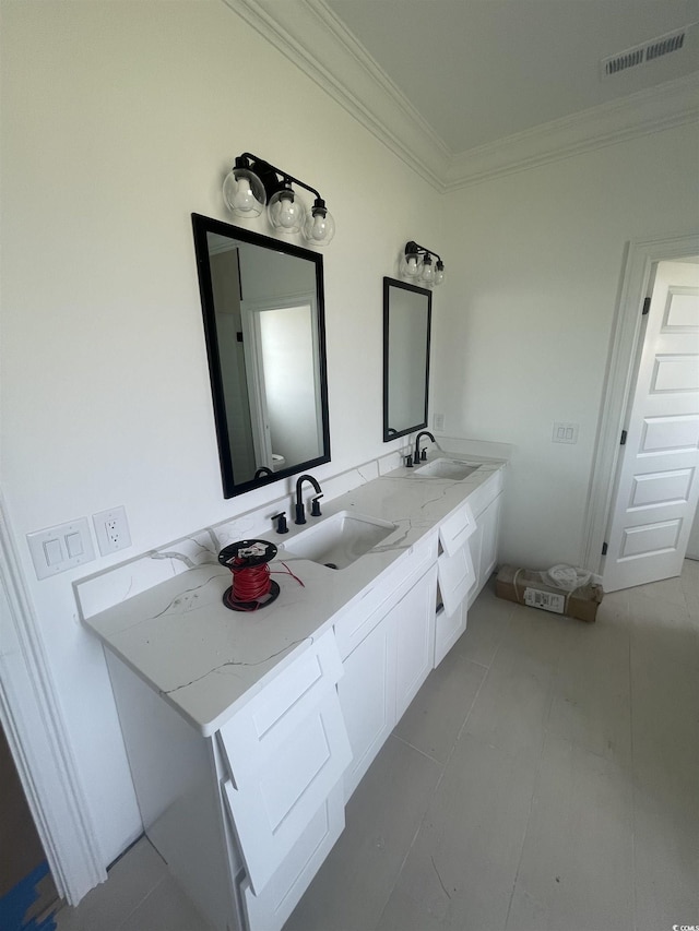 bathroom featuring crown molding and double vanity