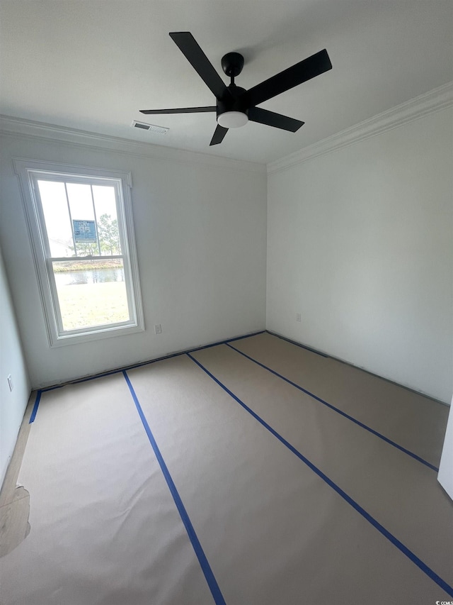 spare room featuring ornamental molding and a ceiling fan