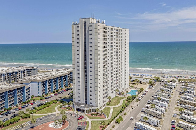 birds eye view of property with a water view and a view of the beach