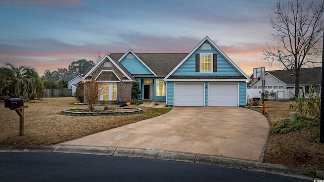 view of front of house featuring a garage, concrete driveway, and fence