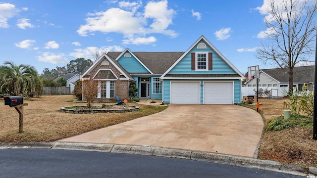 view of front of home featuring a garage, concrete driveway, brick siding, and fence