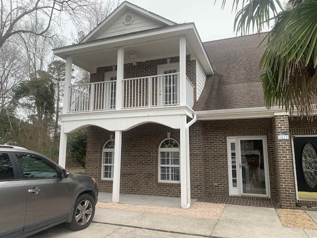 view of front of property with covered porch and a balcony