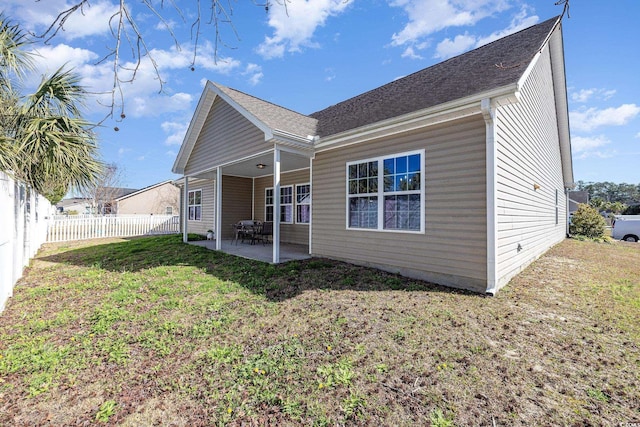 rear view of property with a patio area and a lawn