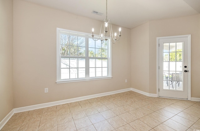 unfurnished dining area with a notable chandelier and light tile patterned floors