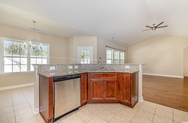 kitchen with a center island with sink, hanging light fixtures, dishwasher, and sink