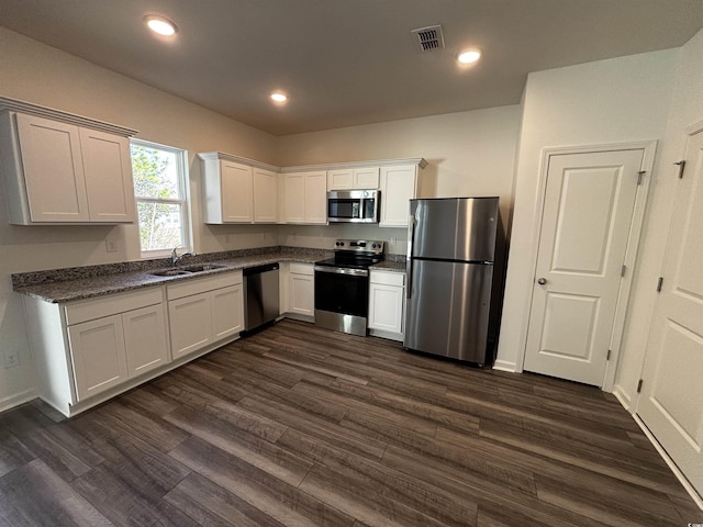 kitchen with white cabinetry, visible vents, stainless steel appliances, and a sink