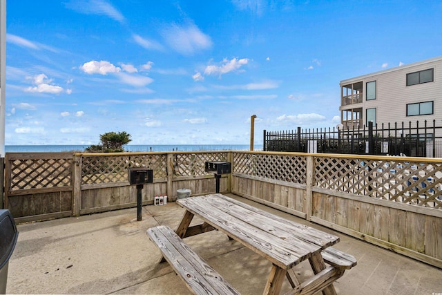 view of property's community with a water view and a patio