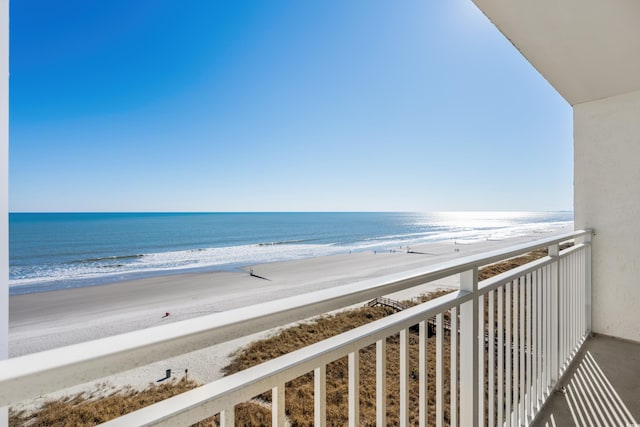 balcony featuring a water view and a view of the beach