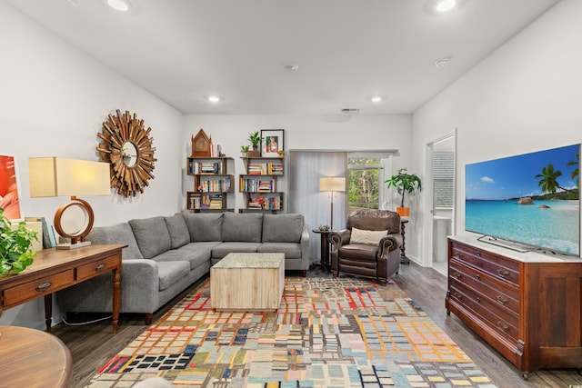 living room with wood finished floors, visible vents, and recessed lighting