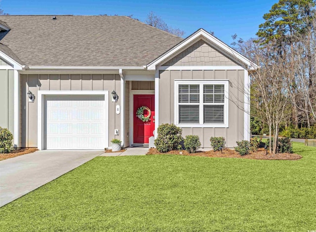 ranch-style home featuring board and batten siding, a front yard, driveway, and an attached garage