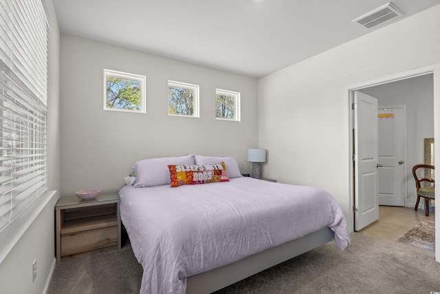 bedroom featuring light carpet and visible vents