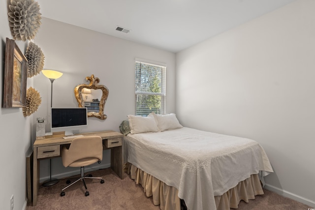 carpeted bedroom featuring visible vents and baseboards