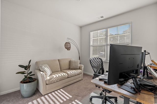 home office featuring visible vents, light carpet, and baseboards