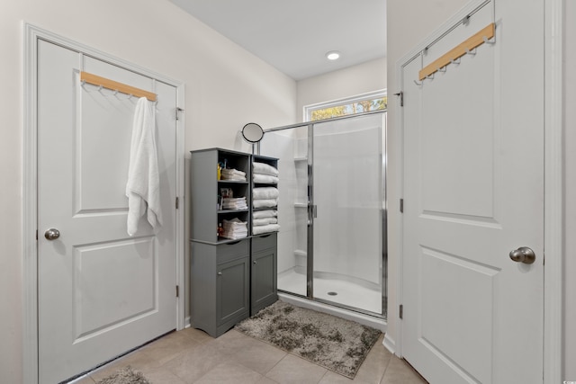 bathroom featuring tile patterned flooring and a shower stall