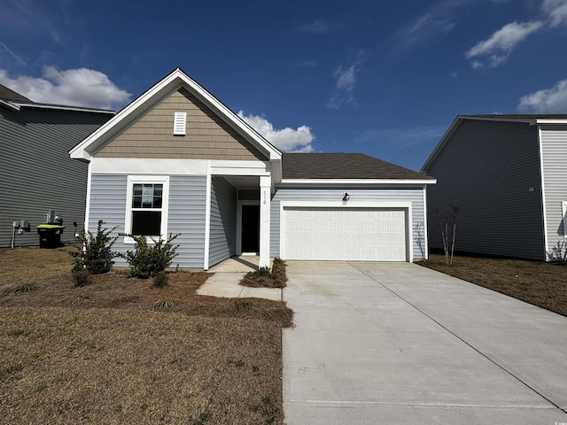 view of front of home featuring a garage, a front yard, driveway, and a shingled roof