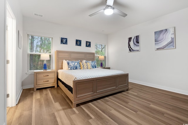 bedroom with light hardwood / wood-style floors and ceiling fan