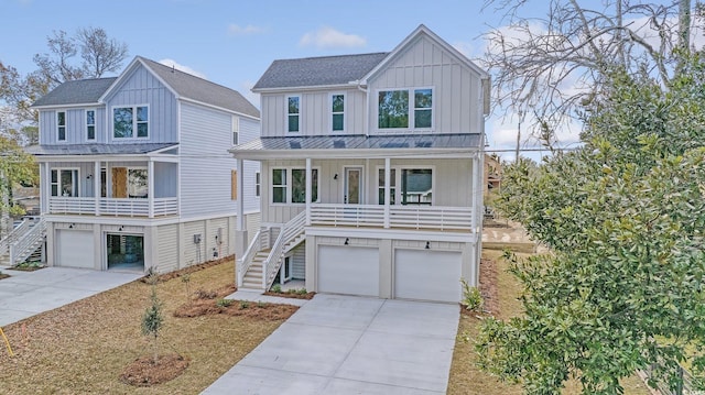 coastal home with stairs, concrete driveway, a porch, and board and batten siding