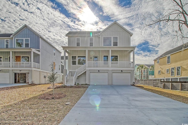 view of front of property featuring fence, a garage, board and batten siding, and concrete driveway