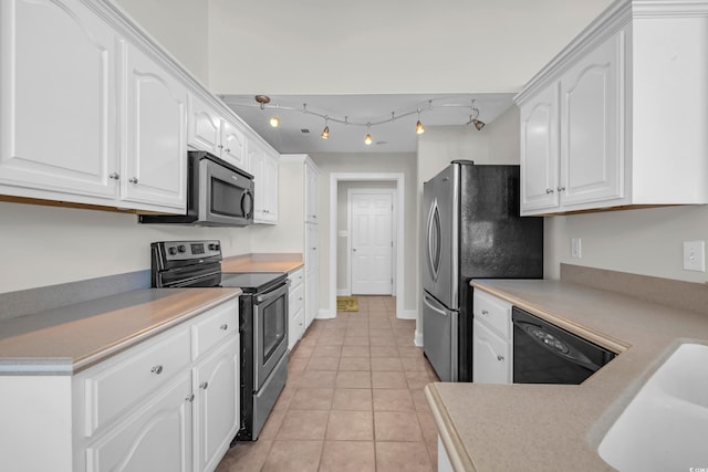 kitchen featuring white cabinets, stainless steel appliances, and light tile patterned floors