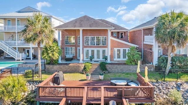 back of house with a patio, a fire pit, and a pool side deck