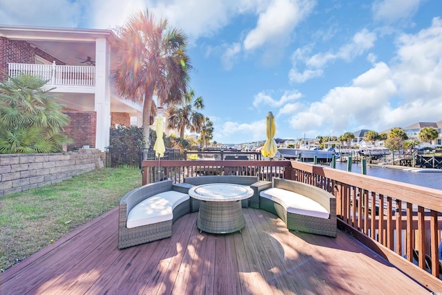 wooden terrace featuring a water view