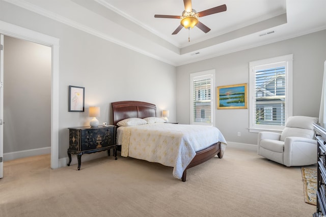 carpeted bedroom featuring ornamental molding, ceiling fan, and a raised ceiling