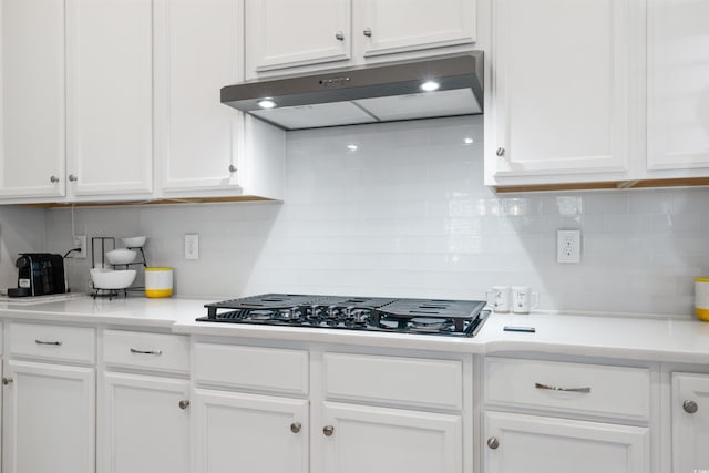 kitchen featuring black gas stovetop and white cabinetry