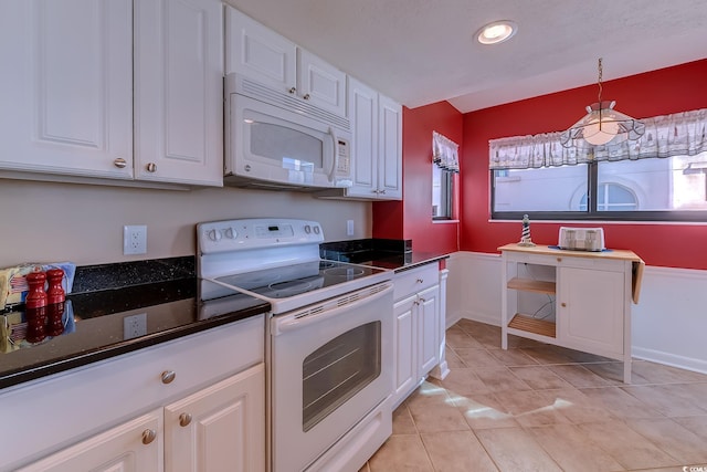 kitchen with white cabinetry, white appliances, light tile patterned flooring, and hanging light fixtures