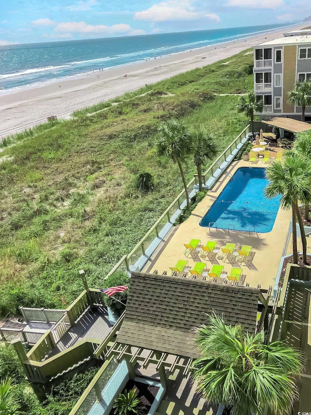 drone / aerial view featuring a water view and a view of the beach