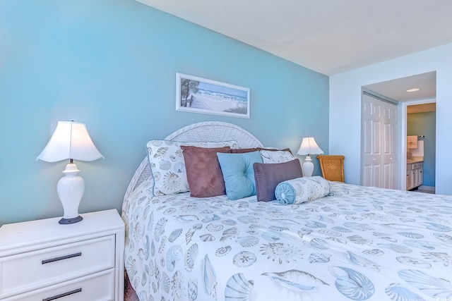 bedroom featuring ensuite bath and a closet