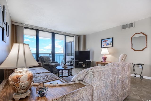 tiled living room featuring floor to ceiling windows