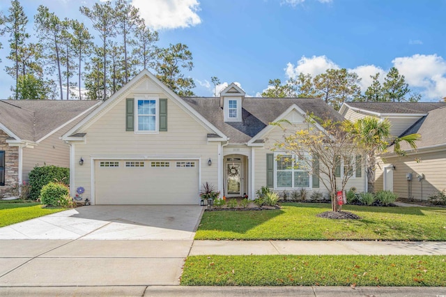 view of front of property featuring a front yard and a garage