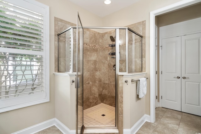 bathroom featuring an enclosed shower and tile patterned floors