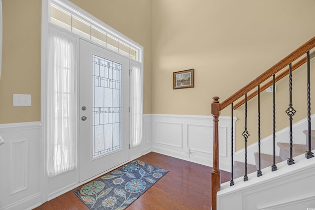 foyer entrance with a healthy amount of sunlight and dark wood-type flooring